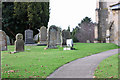 TA0253 : Gravestones at St Peter's, Hutton by Peter Church