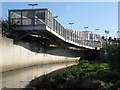 Pedestrian bridge over the River Ravensbourne near Elverson Road DLR station