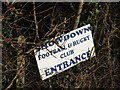 Sign buried in the hedge for the Snowdown football and rugby club