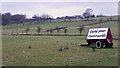 NY8480 : Roadside advertising, Ealingham Farm by Andrew Curtis