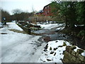 Brookside as it fords the River Medlock