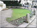 Seats by a small green near the George V Memorial