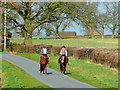 Two riders on a country road