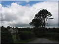 SH5084 : View west towards Henrefail Cottages from the green at Marian-Glas by Eric Jones