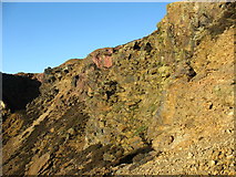 SH4490 : Red coloured rock in the north wall of the eastern open cast working by Eric Jones