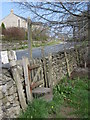 Footpath sign and stile alongside the B6479