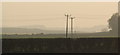 A hazy view across fields between Panbride and Carlogie