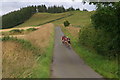 NO3154 : Cyclists descending West Sharroch, between Kirkton of Kingoldrum and Lintrathen by Mike Pennington