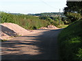 SX9199 : Lane with road repair materials in the layby near Sevenstone Barton, looking south by Rob Purvis