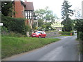 Car branching off Carding Mill Valley for the golf club