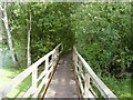 Footbridge across flooded gravel pits