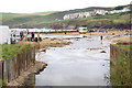 Stream discharging across Polzeath beach