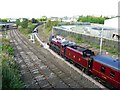 Steam train standing under St. Nicholas Bridge