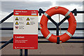 A sign and lifebelt at Spittal Beach