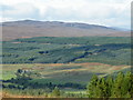 NH2811 : Looking down on Dalchreichart from Inverwick Forest by Sarah McGuire