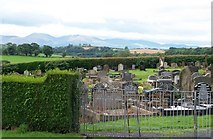 J4844 : View across the graveyard of Downpatrick Cathedral towards the Mourne Mountains by Eric Jones