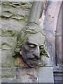 Male stone head on Christ Church west doorway