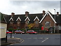 Crediton - almshouses and the junction of Church Lane with the A377