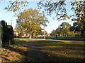 Approaching the junction of an autumnal Riders Lane and Eversley Crescent