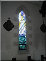 Stained glass window on the north wall at  St Coleman