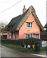 Thatched pink cottage