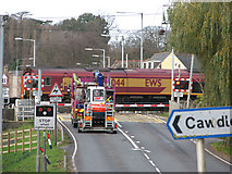 TL5479 : EWS freight line passing level crossing by Evelyn Simak