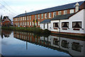 Long building by the River Colne