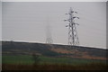 SJ9897 : Electric pylons on the side of Wildbank Hill by Bill Boaden
