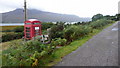 Red phone box on isolated lane.