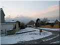 Junction of  a snowy Dormington Road and  Mortimer Road