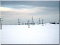NZ4433 : Pylons in a snowy field near High Volts Farm (view east) by Philip Barker