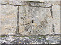 Scratch or mass dial on church porch