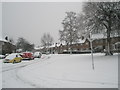 Junction of a snowy Woodgreen Avenue and Harestock Road