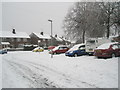 Looking from a snowy Harestock Road down to Woodgreen Avenue