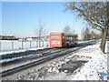 Bus passing a snowy Park Community School