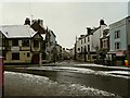 Boutport Street continuing to The Square whilst Queens Street commences on the left