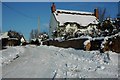 Thatched cottage in the snow