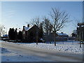 Approaching the junction of a snowy St Albans Road and Liam Close