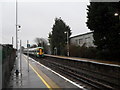 Train from Brighton arriving at a very wet Angmering Station