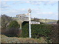 A road sign at the junction of the A396 and the B3224 at Wheddon Cross