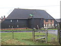 Greensand Way stile and Bond Farm Barn