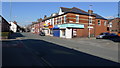 A row of shops and houses on Reddish Lane