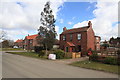 Village Post Box and view of new infill housing, Biggin