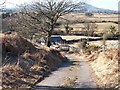 Ystum-cegid Farm access road descending westwards towards the bridge over Afon Dwyfor