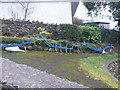 A row of old ploughs used as garden decor, Llanddoged