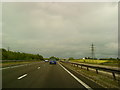 SP2198 : Power lines cross the M42 by Andrew Abbott