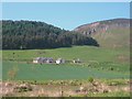 Farm on the foot of Duninsane Hill with the rocky crags of Black Hill beyond