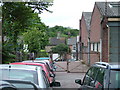 Wonky gates beside car dealer