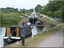 ST9761 : Two narrow boats descend the Caen Hill Locks by Russel Wills
