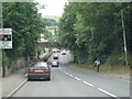 Road dips under a railway bridge